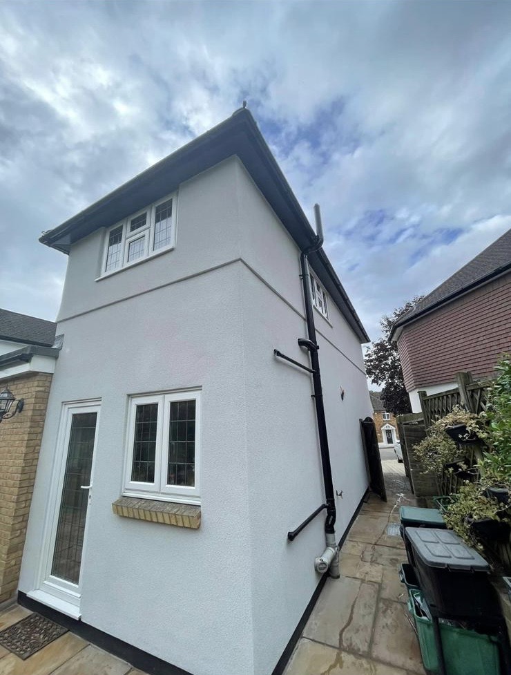 Finished white spray cork house exterior by ALT Spray Cork